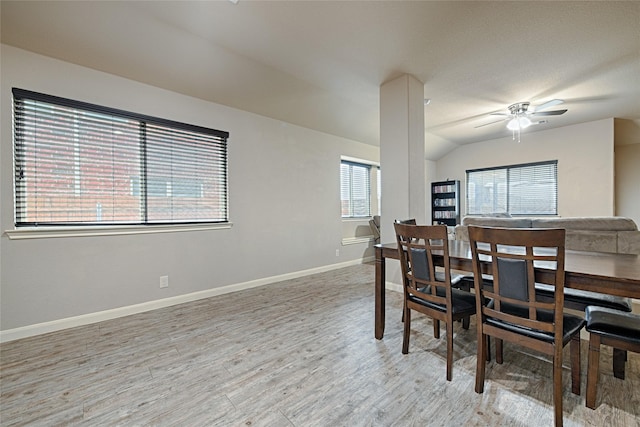 dining area with vaulted ceiling, wood finished floors, baseboards, and ceiling fan