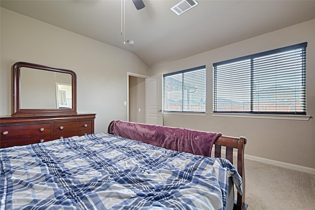 carpeted bedroom featuring baseboards, a ceiling fan, vaulted ceiling, and visible vents