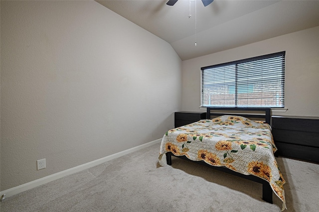 carpeted bedroom with vaulted ceiling, a ceiling fan, and baseboards