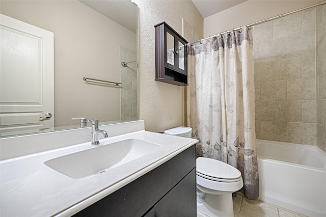 full bathroom featuring toilet, tile patterned flooring, shower / bathtub combination with curtain, a textured wall, and vanity