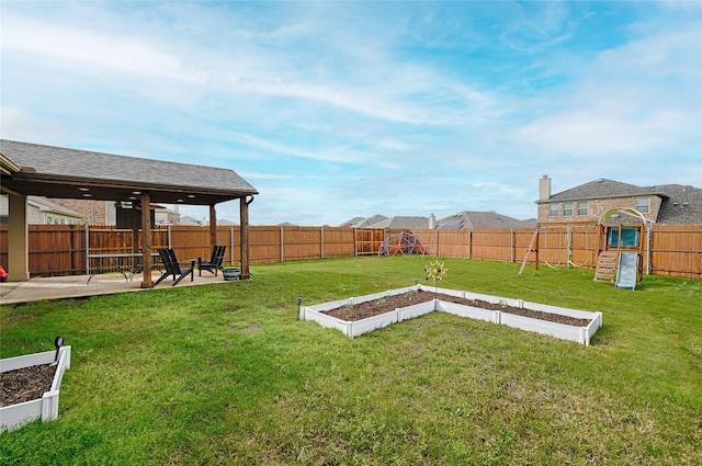 view of yard featuring a patio area, a fenced backyard, a garden, and a playground