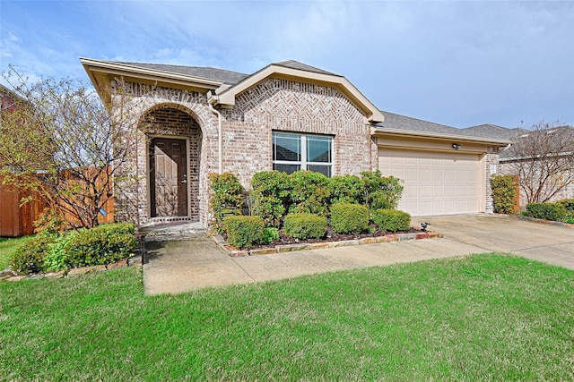 view of front of home with an attached garage, a front lawn, driveway, and brick siding