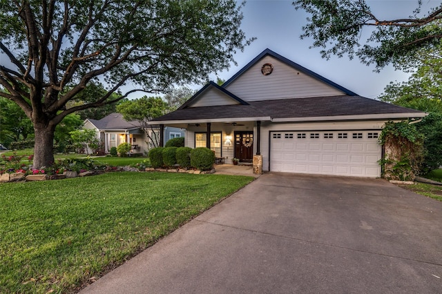 ranch-style home featuring a ceiling fan, concrete driveway, covered porch, a front yard, and a garage