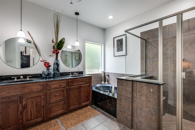 full bathroom featuring double vanity, a garden tub, tiled shower, and a sink