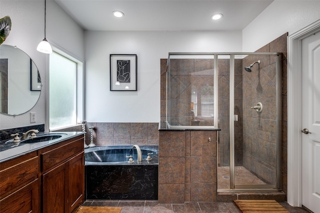 full bathroom featuring a garden tub, vanity, a shower stall, and a healthy amount of sunlight