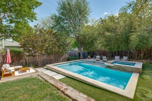 view of swimming pool featuring a fenced backyard, a yard, a patio, and a pool with connected hot tub