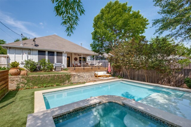 view of swimming pool with a patio area, a fenced backyard, a grill, and an in ground hot tub