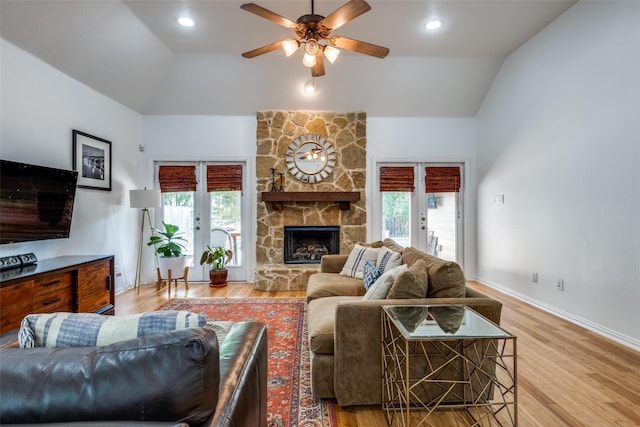 living area with lofted ceiling, a ceiling fan, french doors, and a wealth of natural light