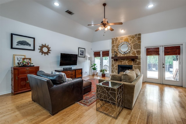living room featuring visible vents, light wood finished floors, ceiling fan, and french doors