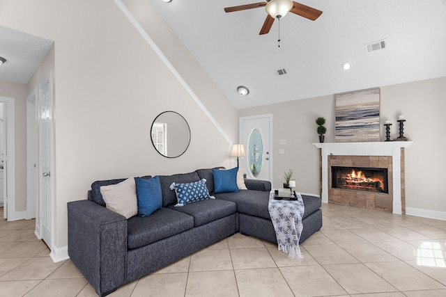 1014 S Ballard Ave, Wylie, TX 75098 - living room featuring ceiling fan, light tile patterned floors, vaulted ceiling, a fireplace, and baseboards
