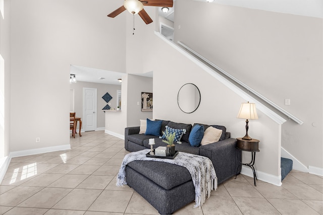 1014 S Ballard Ave, Wylie, TX 75098 - living room featuring stairway, light tile patterned flooring, ceiling fan, baseboards, and a high ceiling