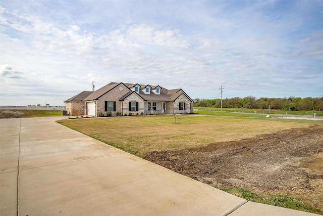 view of front of home with a garage, driveway, stone siding, and a front lawn