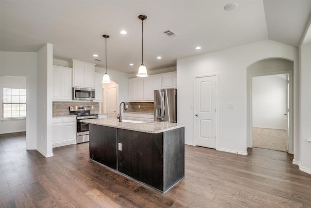 kitchen featuring white cabinets, visible vents, a sink, baseboards, and appliances with stainless steel finishes