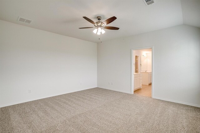 spare room featuring baseboards, a ceiling fan, visible vents, and light colored carpet