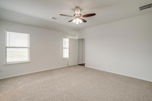 unfurnished room with ceiling fan, a healthy amount of sunlight, baseboards, carpet flooring, and visible vents