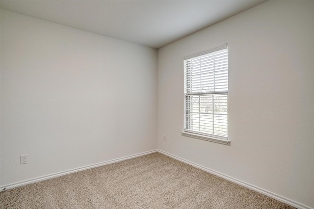 carpeted spare room with baseboards