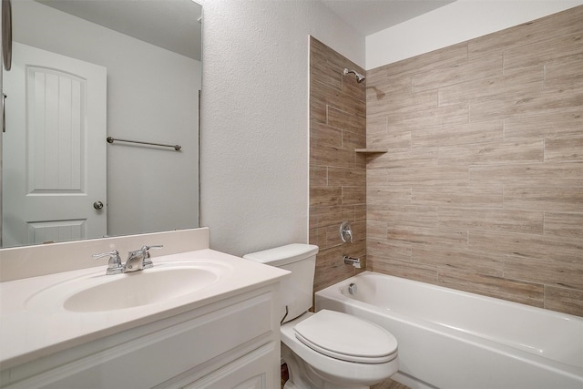 bathroom with a textured wall, shower / bathtub combination, vanity, and toilet