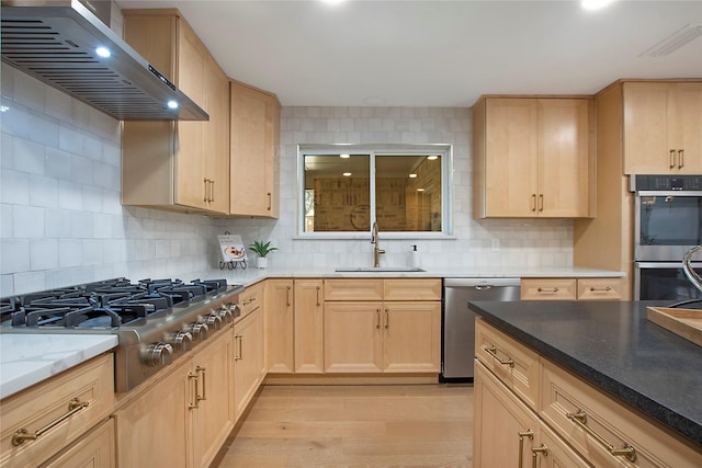 9603 Greensprint Dr, Dallas, TX 75238 - kitchen with light brown cabinetry, stainless steel appliances, and wall chimney range hood