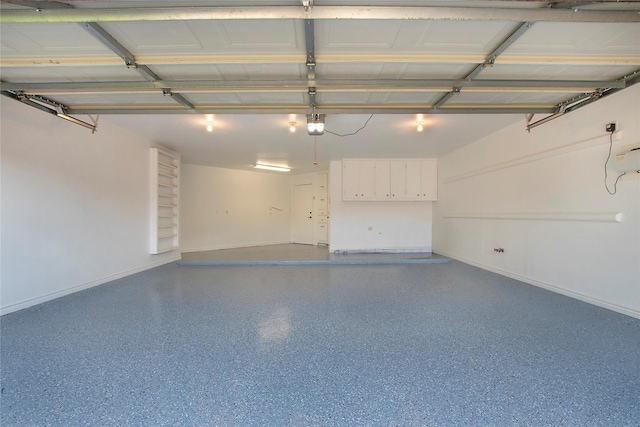 9603 Greensprint Dr, Dallas, TX 75238 - garage featuring baseboards and a garage door opener