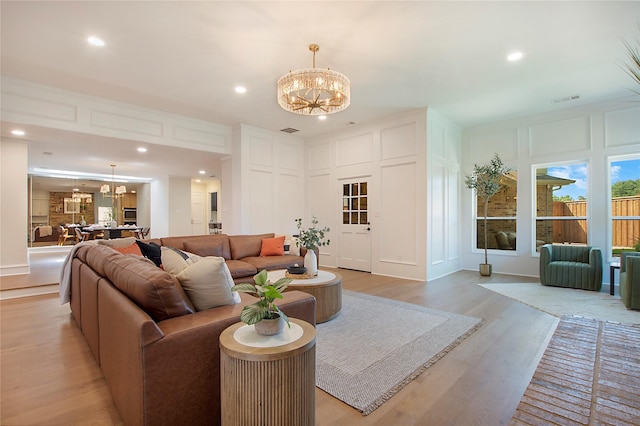 9603 Greensprint Dr, Dallas, TX 75238 - living area featuring a chandelier, light wood finished floors, a decorative wall, and recessed lighting