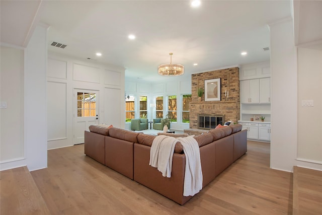 9603 Greensprint Dr, Dallas, TX 75238 - living room with ornamental molding, a decorative wall, a chandelier, a brick fireplace, and recessed lighting