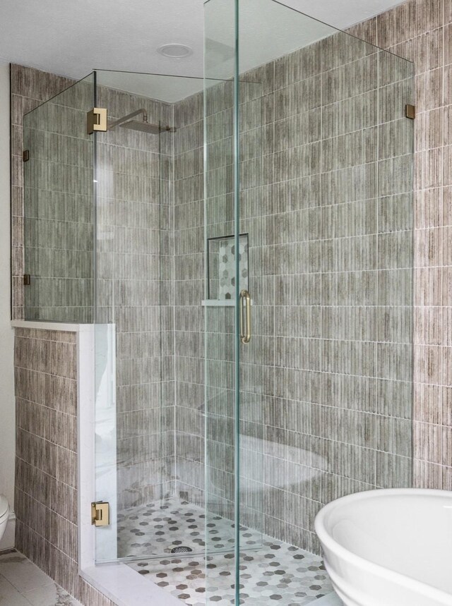 9603 Greensprint Dr, Dallas, TX 75238 - bathroom with tile patterned floors, a shower stall, and tile walls