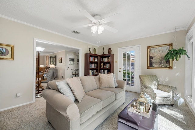 living area featuring a ceiling fan, light carpet, baseboards, ornamental molding, and visible vents