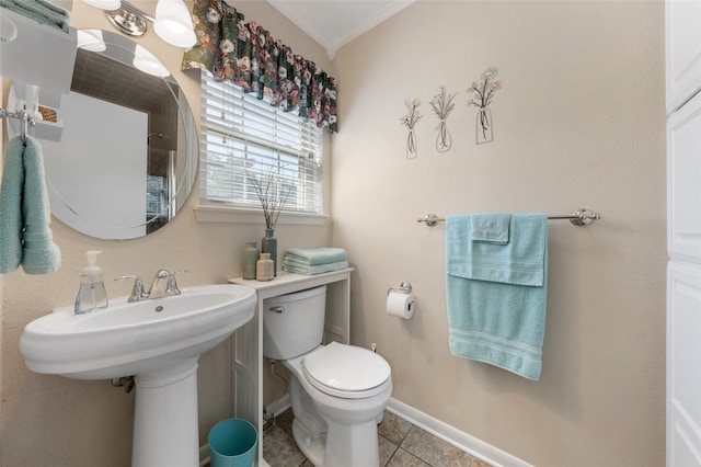 bathroom featuring toilet, baseboards, ornamental molding, and tile patterned floors
