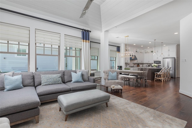 living room with baseboards, a wealth of natural light, recessed lighting, and dark wood finished floors