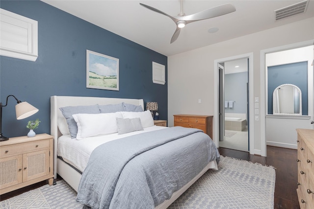 bedroom featuring ensuite bath, wood finished floors, visible vents, and a ceiling fan