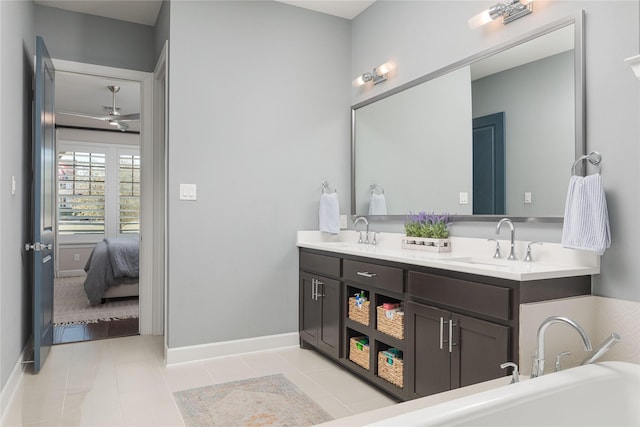 ensuite bathroom with tile patterned floors, a sink, and double vanity