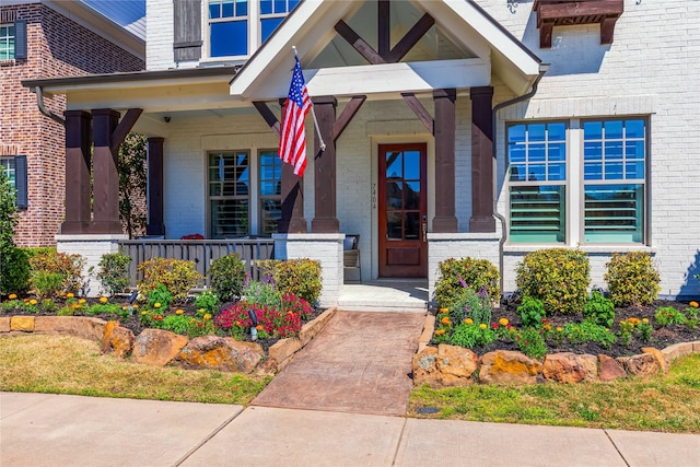 property entrance with brick siding and covered porch