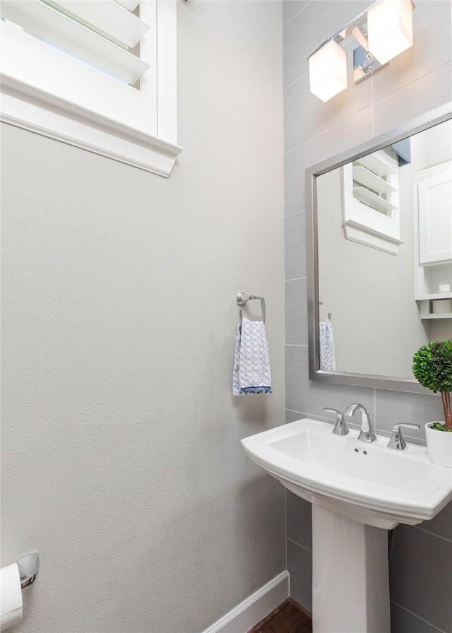 bathroom with baseboards and a sink
