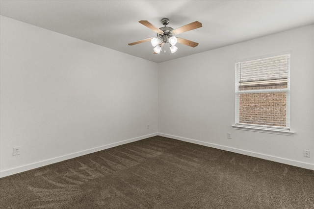 unfurnished room with a ceiling fan, baseboards, and dark carpet