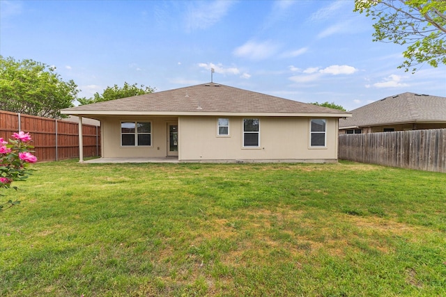 back of house with a lawn, a fenced backyard, and a patio