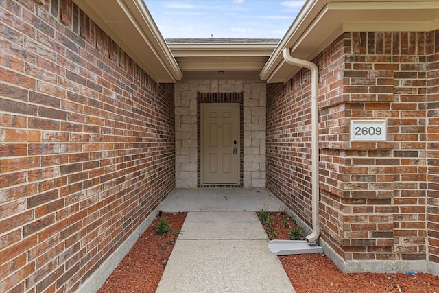 entrance to property with brick siding