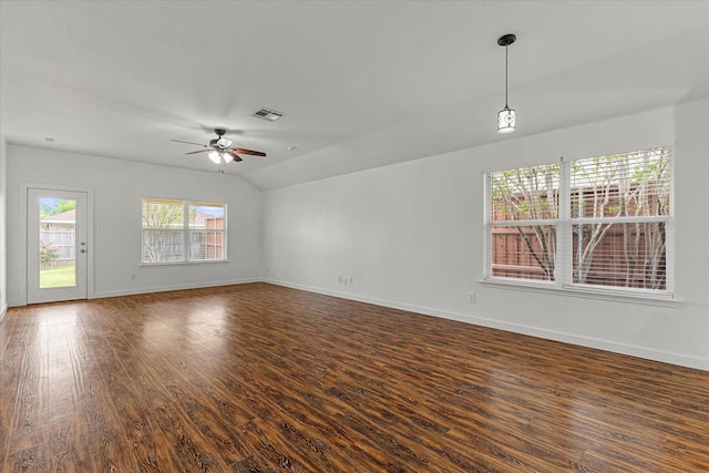 unfurnished living room featuring baseboards, a ceiling fan, visible vents, and dark wood-type flooring