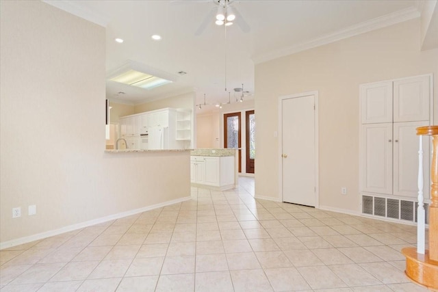 unfurnished room featuring visible vents, crown molding, and baseboards