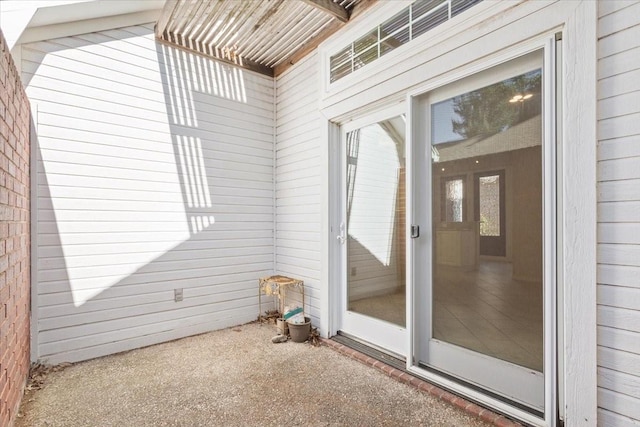 view of exterior entry featuring a patio