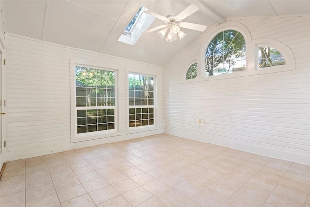 unfurnished sunroom featuring a skylight and beam ceiling