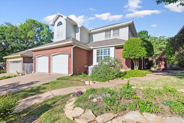 traditional-style house featuring brick siding, driveway, and a garage