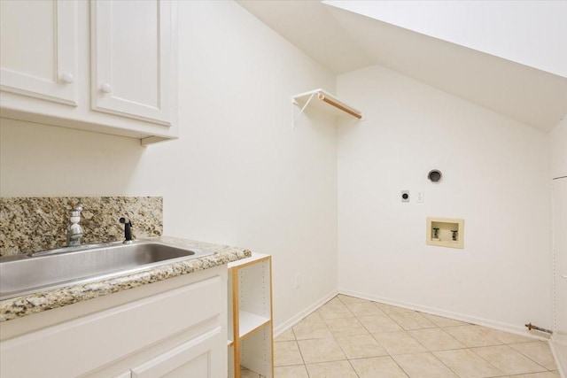 laundry room featuring light tile patterned floors, a sink, electric dryer hookup, cabinet space, and washer hookup