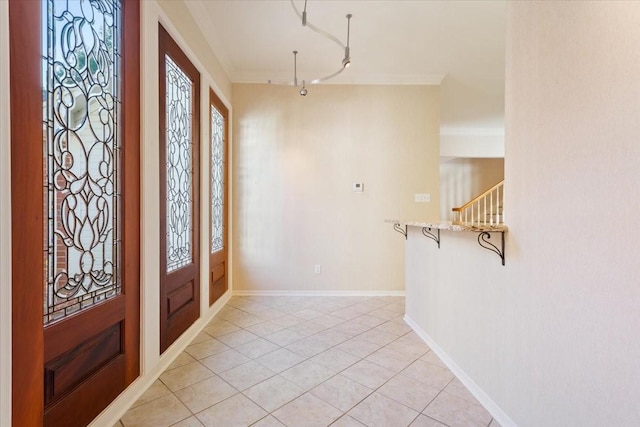 foyer featuring baseboards, a wealth of natural light, and light tile patterned floors