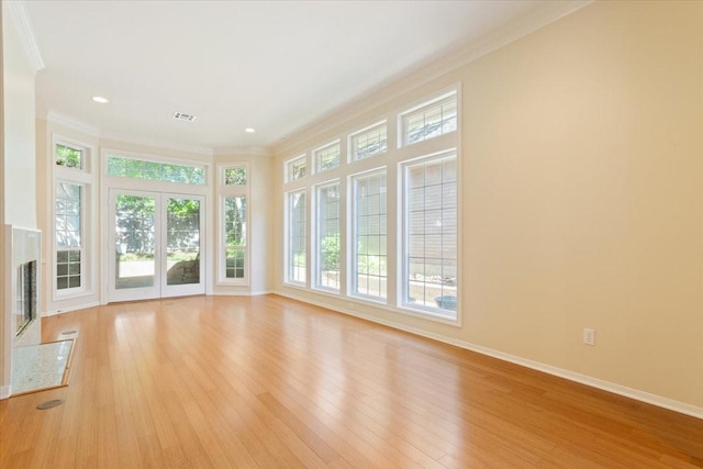 interior space with baseboards, recessed lighting, light wood-style floors, and crown molding