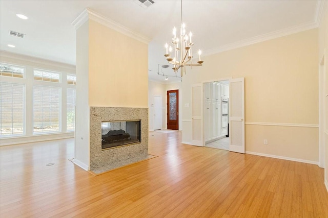unfurnished living room featuring light wood finished floors, a multi sided fireplace, a chandelier, and ornamental molding