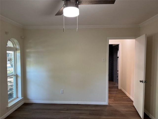 unfurnished room featuring baseboards, ornamental molding, and dark wood-style floors