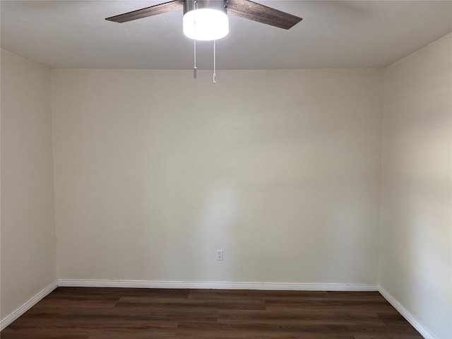 empty room featuring a ceiling fan, baseboards, and dark wood-style flooring