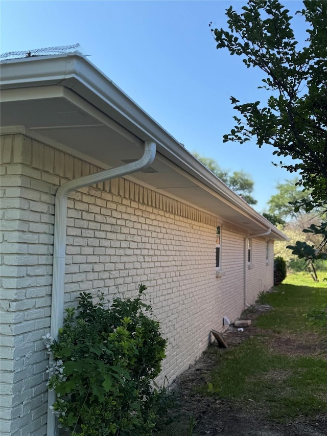 view of side of home featuring brick siding