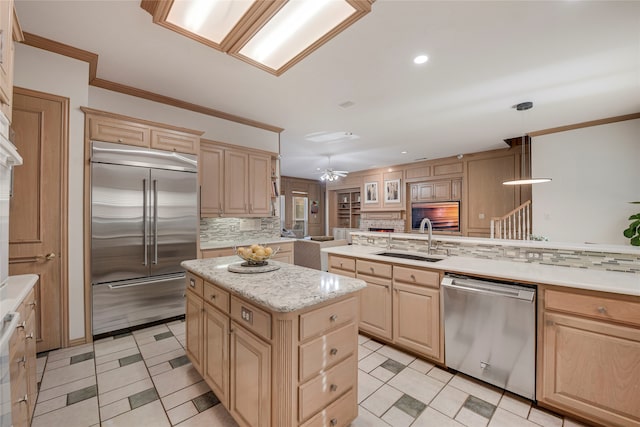 4524 Tuscany Dr, Plano, TX 75093 - kitchen with stainless steel appliances, light brown cabinets, a sink, crown molding, and recessed lighting