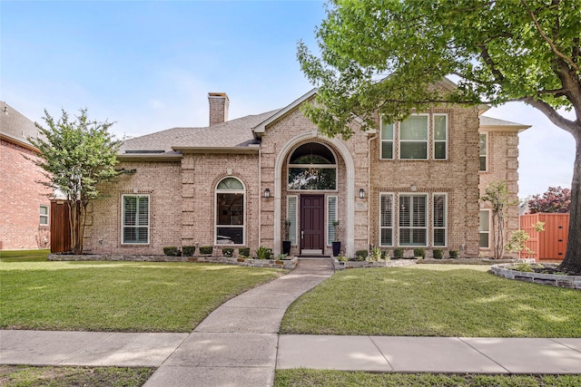 4524 Tuscany Dr, Plano, TX 75093 - traditional-style house featuring brick siding, a chimney, and roof with shingles